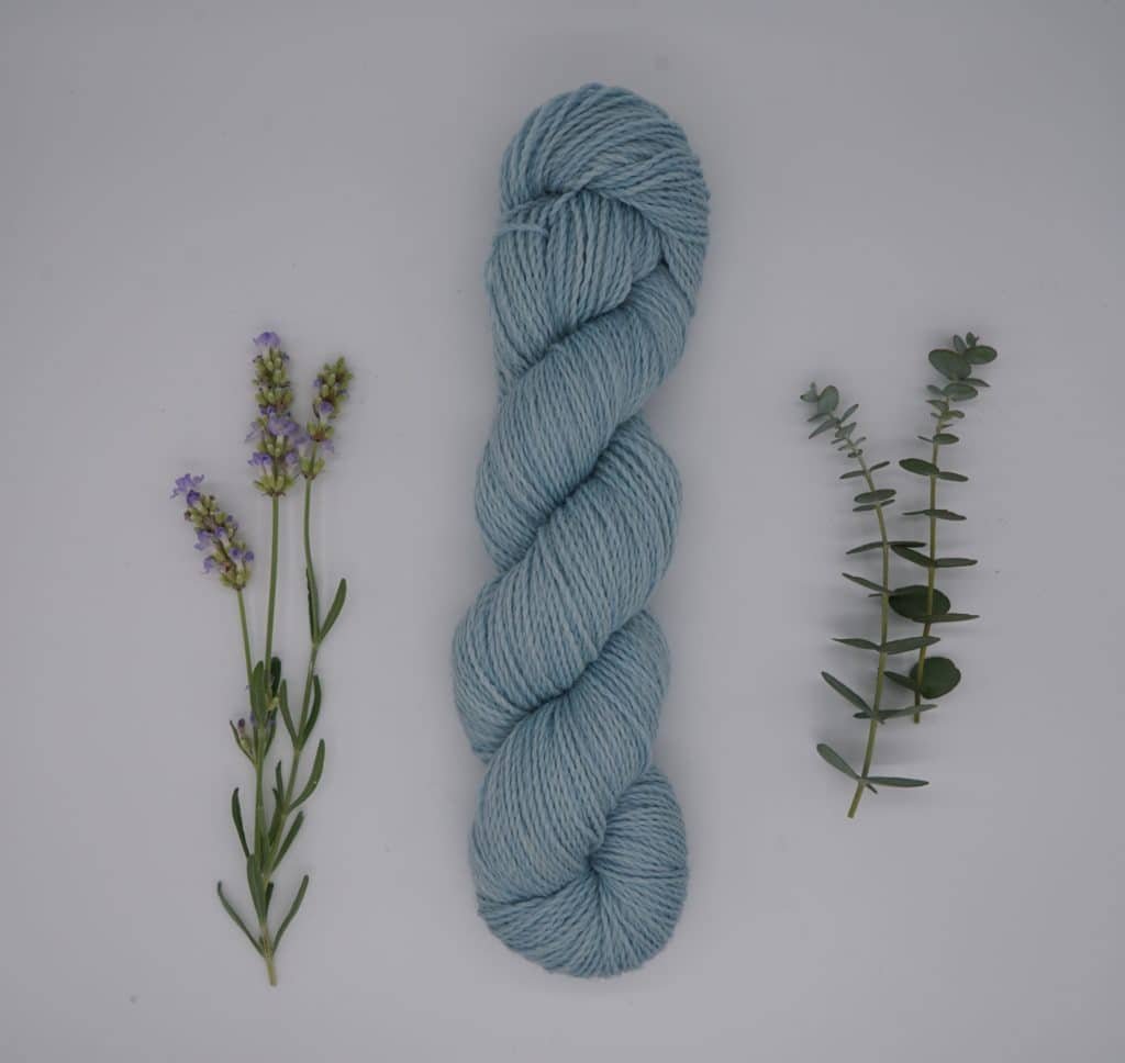 naturally dyed skein of yarn with flowers and leaves