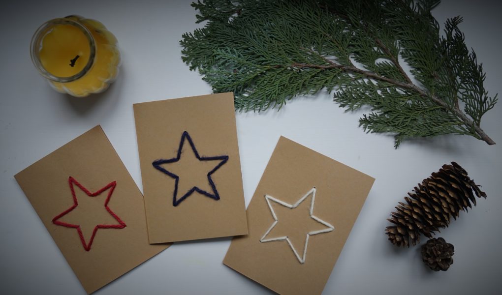 three cardboard cards with a star embroidered on them