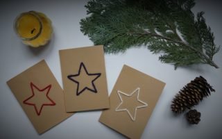 three cardboard cards with a star embroidered on them