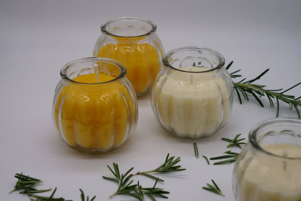 two beeswax and two rapeseed wax candles in glass jars