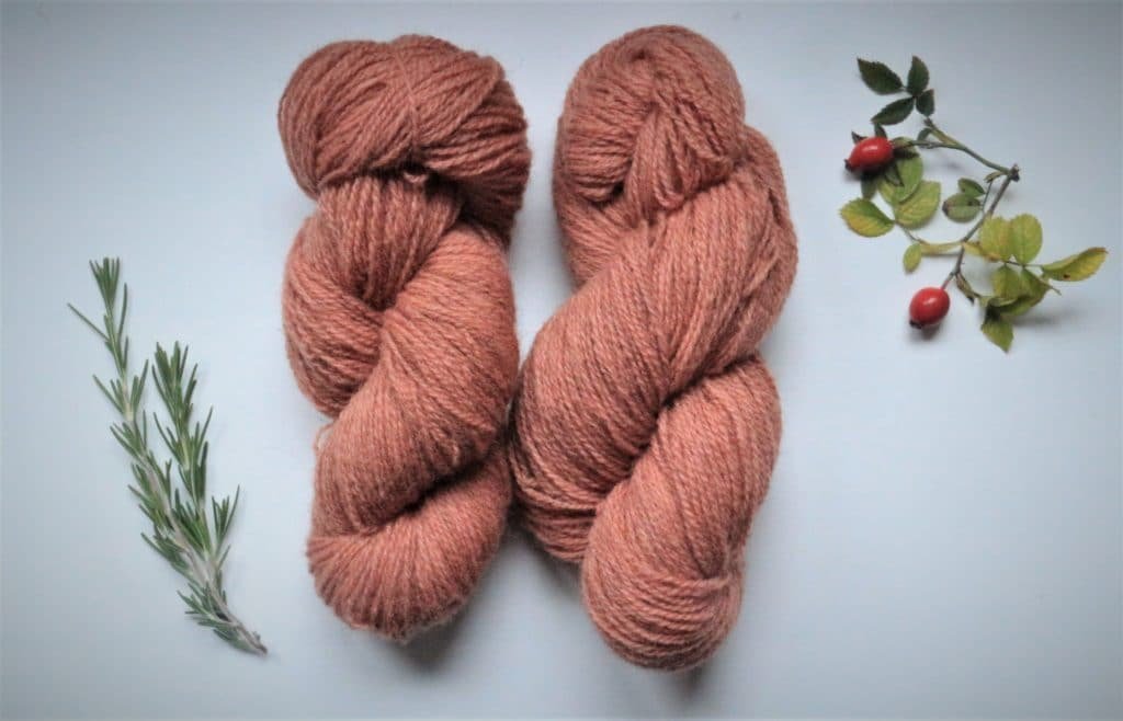 two naturally dyed pink/red/orange skeins of Coburger Fuchsschaf yarn