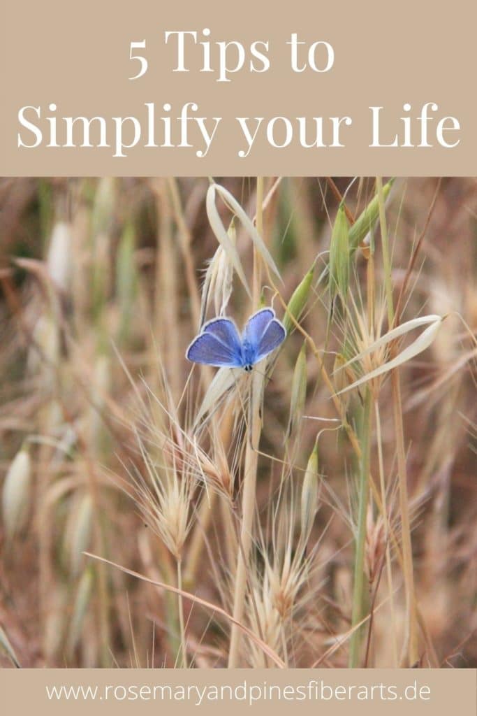blue butterfly in a wheat field and a text saying "5 tips how to simplify your life. www.rosemaryandpinesfiberarts.de"