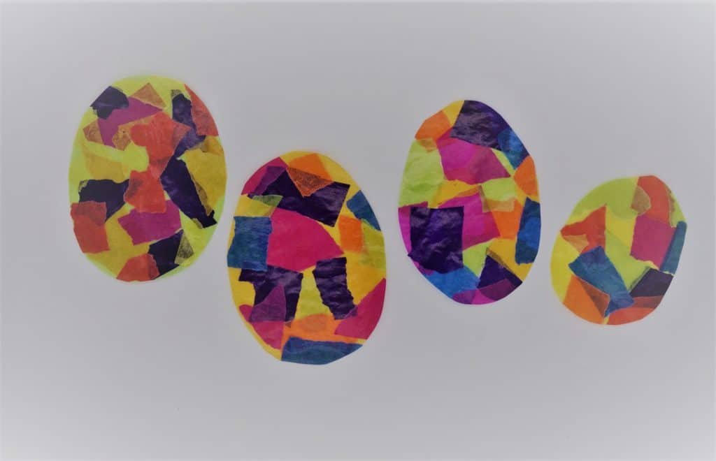 four Easter eggs made out of colourful paper looking like mosaics