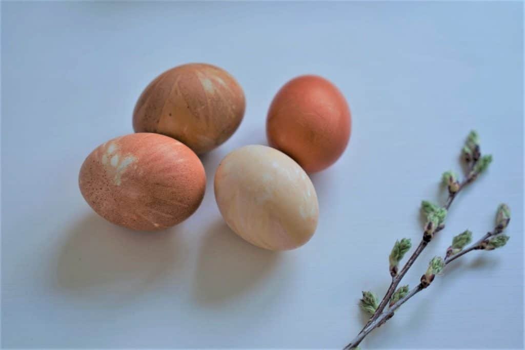 four eggs in orange and yellow colours, naturally dyed with onion skins