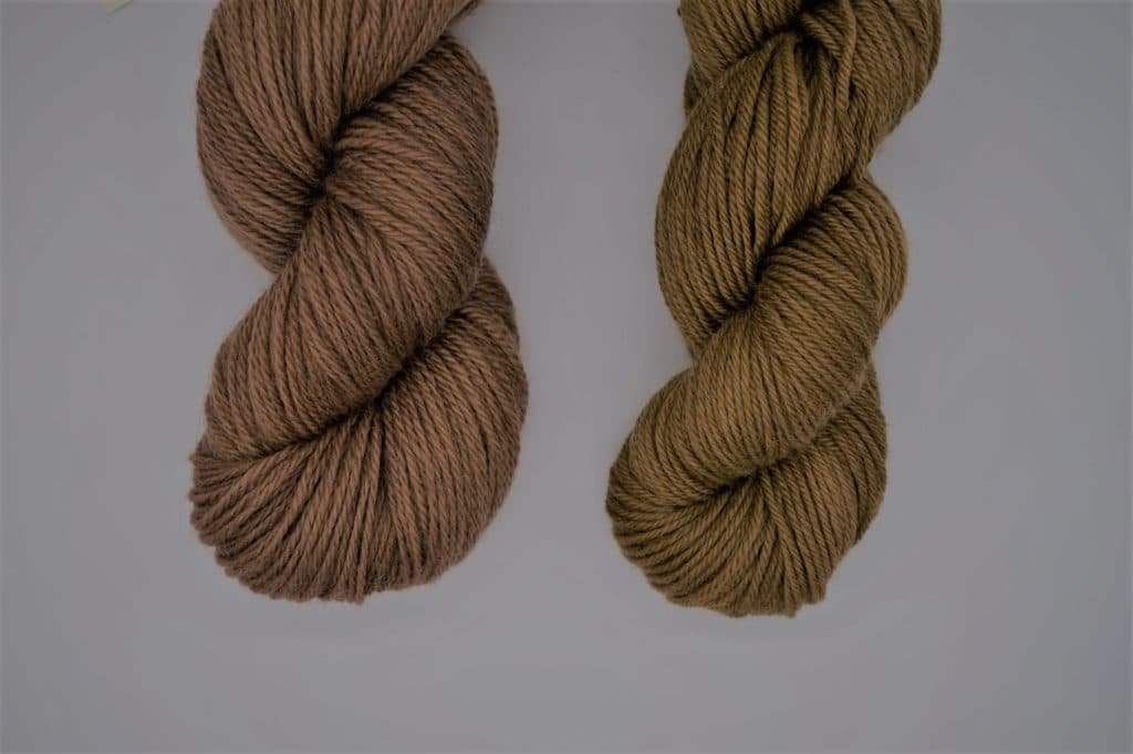 two skeins of yarn naturally dyed with walnut and chestnut husks