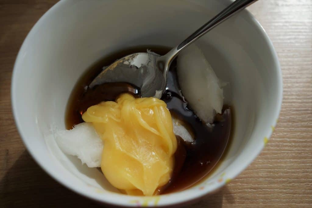 honey, coconut oil and maple syrup in a small bowl and a spoon