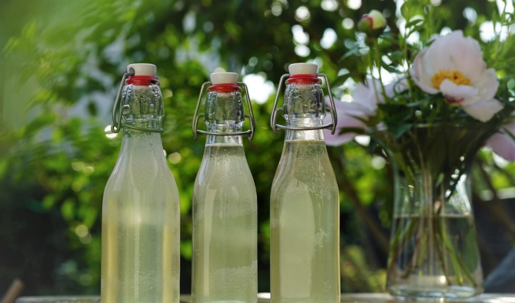 three glass bottles of homemade elderflower cordial