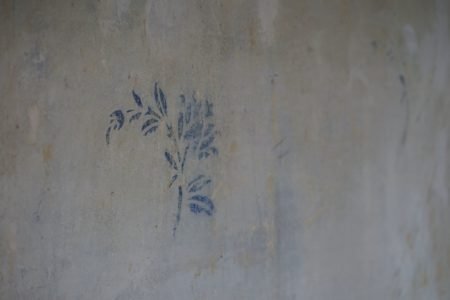 blue flower pattern on a concrete wall