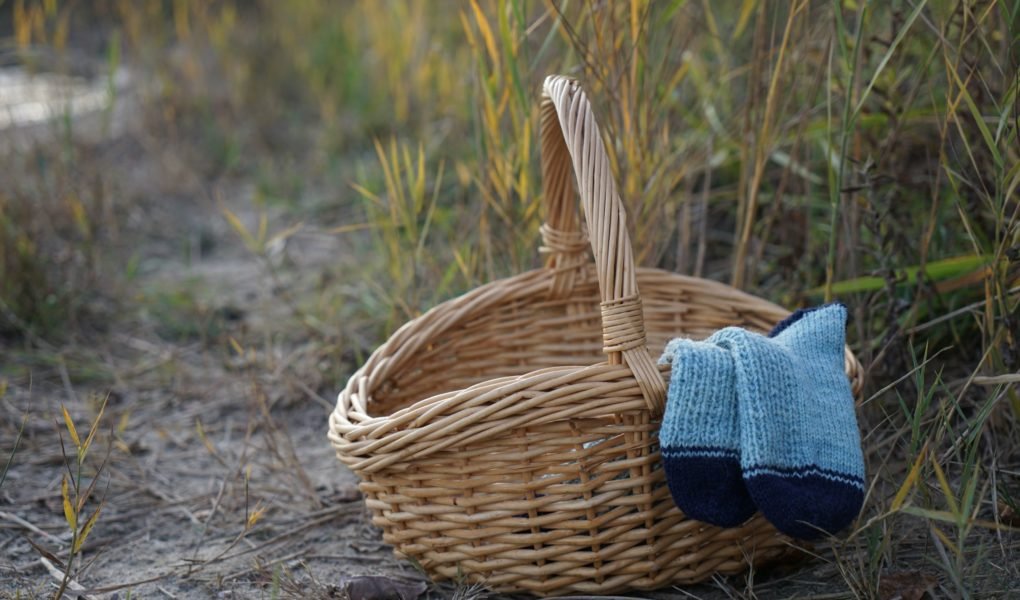 camaret socks peeking out of a wooden basket