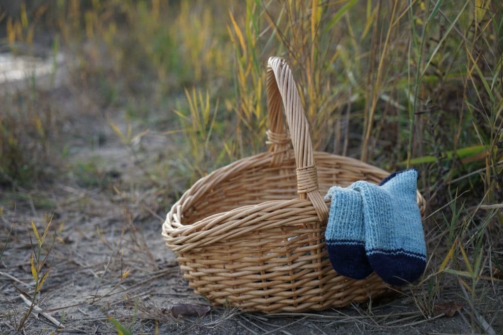 camaret socks peeking out of a wooden basket