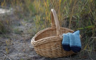camaret socks peeking out of a wooden basket