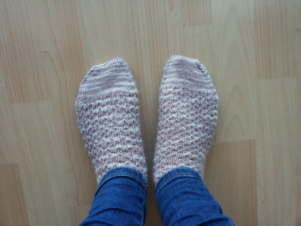 dusty pink hermiones everyday socks on a light wooden floor