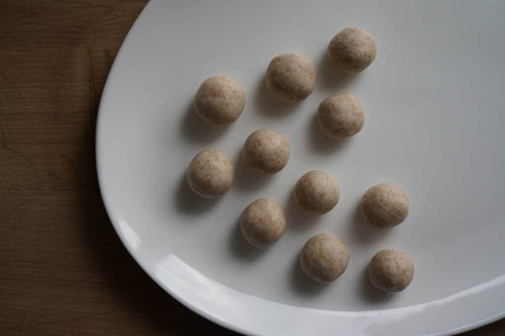 play dough balls sitting on a white plate