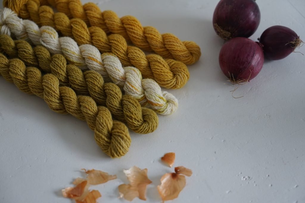 five mini skeins of yarn naturally dyed with onion skins