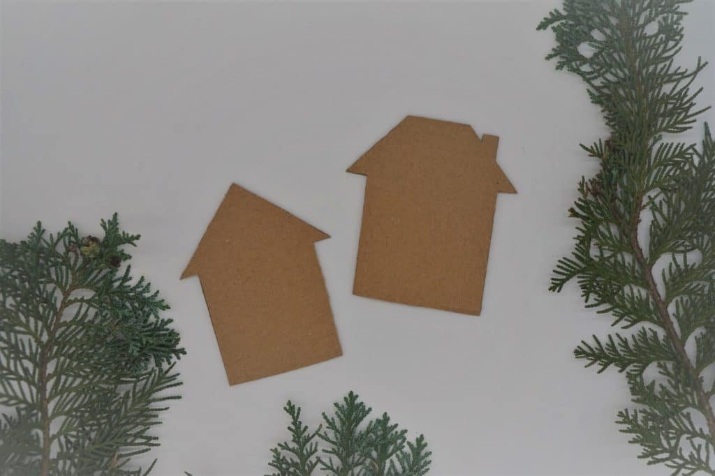 two house silhouettes cut out from a cardboard box