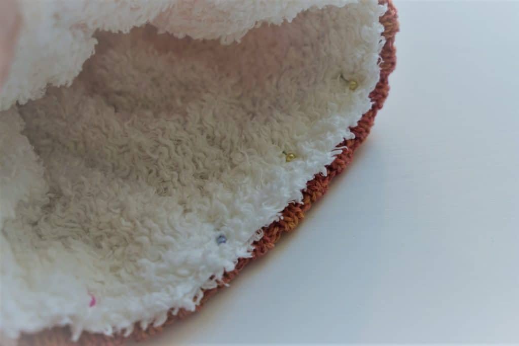 pining lining into a knitted hat