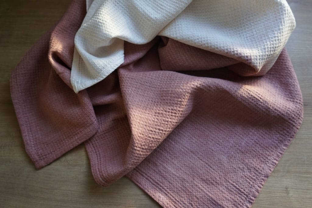 two kitchen towels naturally dyed with avocado skins