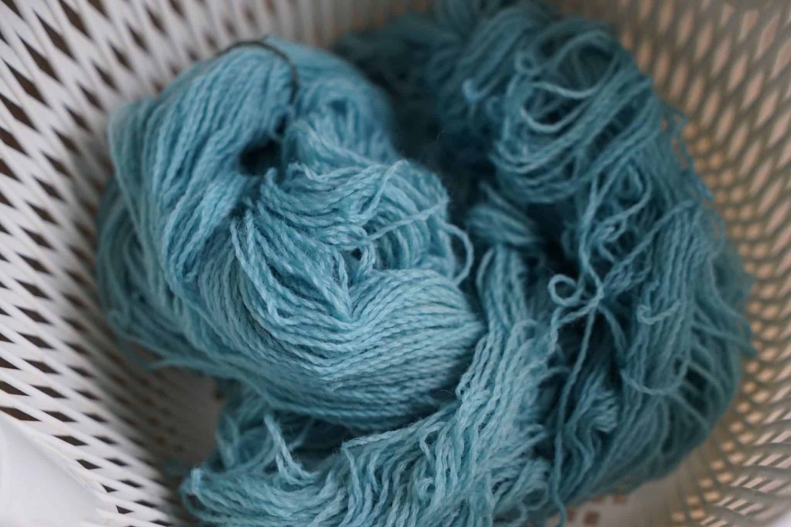 indigo dyed skein of yarn in mid tone to darker shade of blue