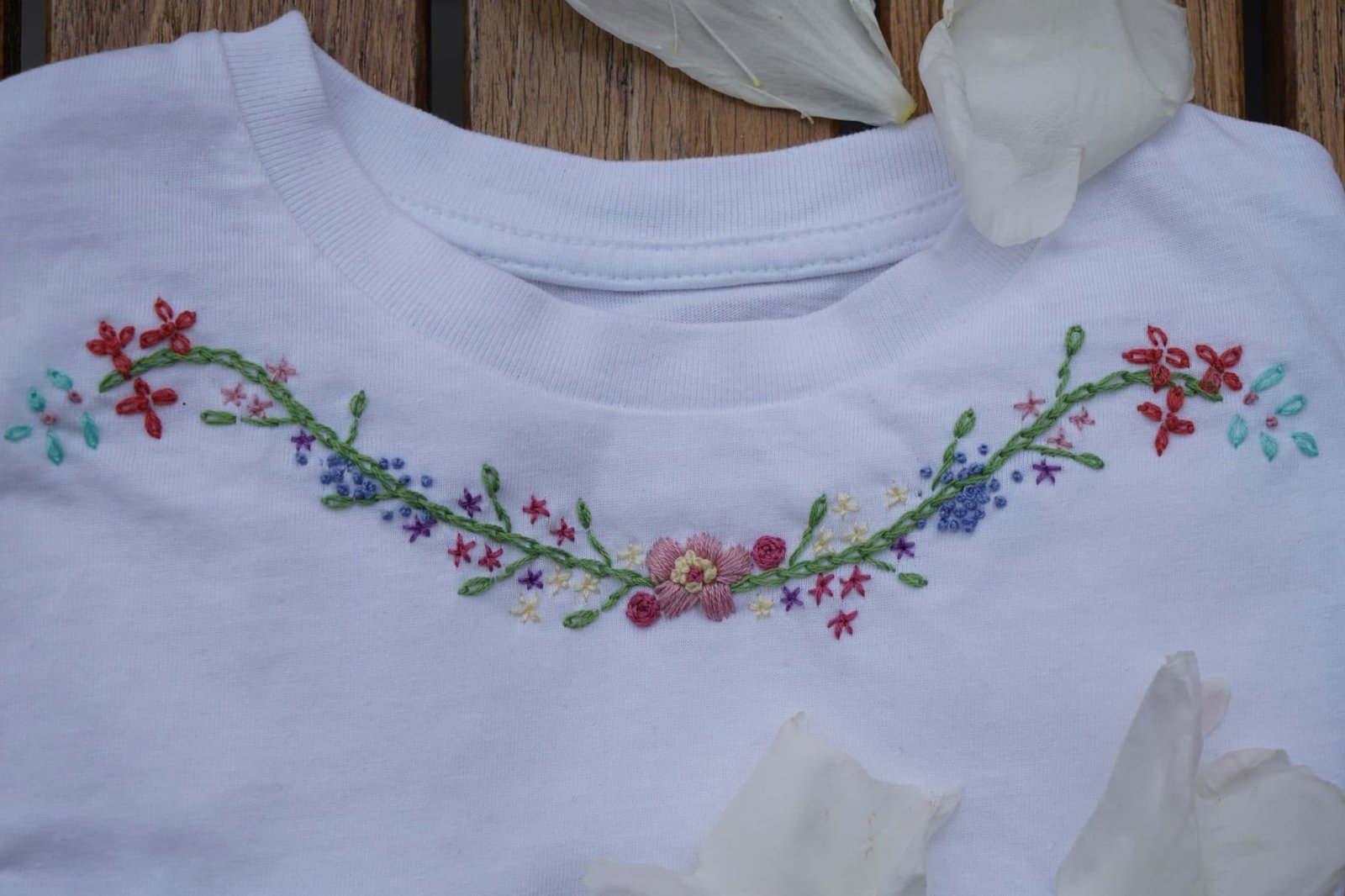 white cotton shirt with floral border embroidery and pink peony petals