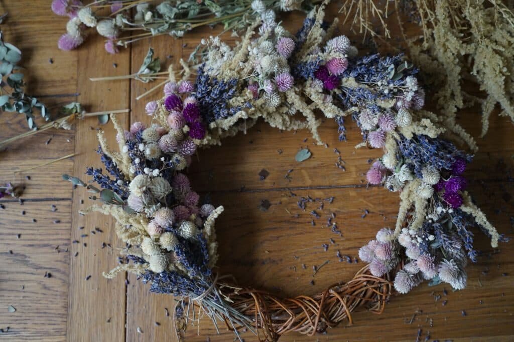 dried flower wreath on a willow base almost done