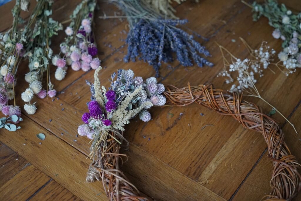 adding flower bundles to the wreath