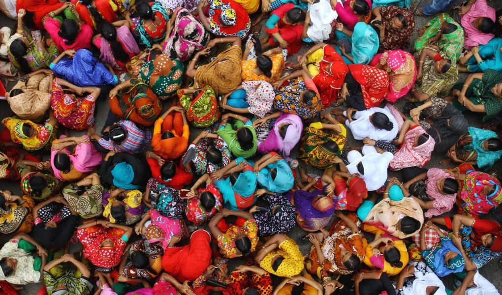 overhead shot of female garment workers in Bangladesh in colorful clothing
