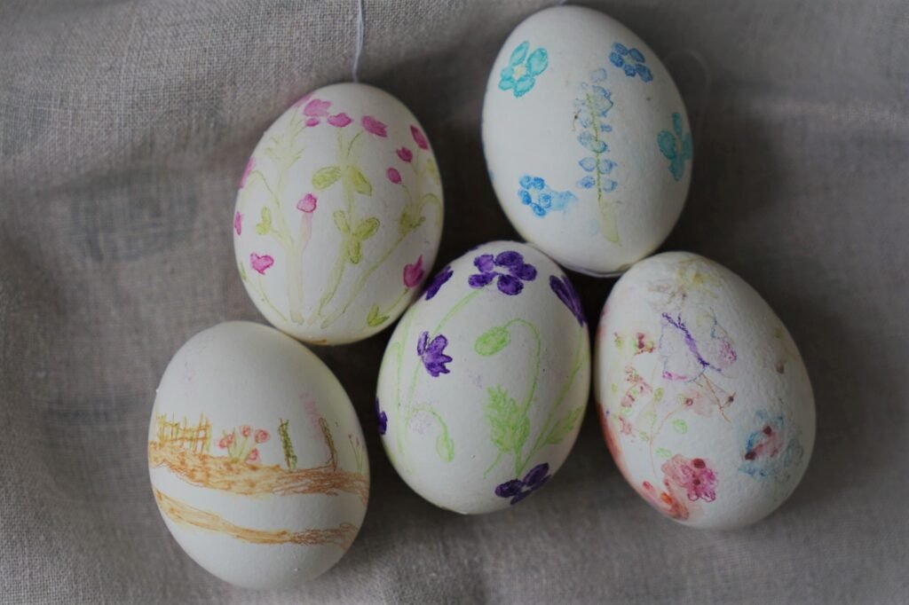 five hand painted watercolor easter eggs on a linen dish towel