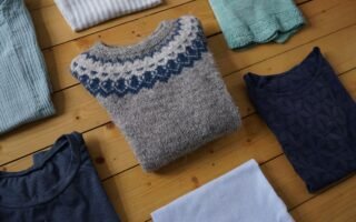handmade garments folded and lying on a wooden floor