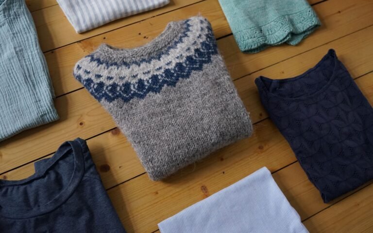 handmade garments folded and lying on a wooden floor