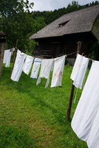 several pieces of clothing and sheets hanging on a clothesline