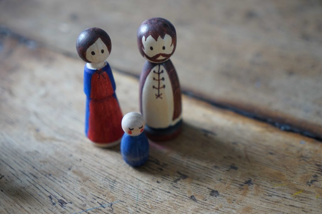 hand painted wooden peg dolls looking like Maria, Joseph and baby Jesus