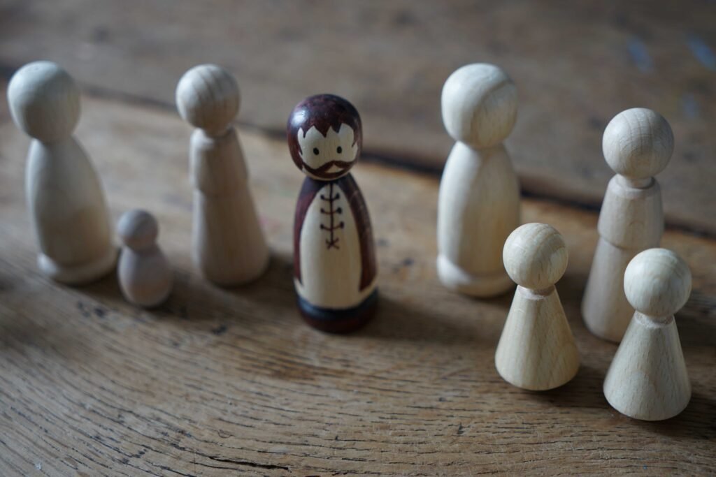 wooden peg dolls, one is already painted and the others are unfinished