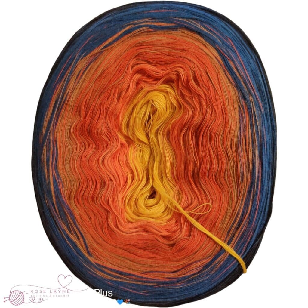 yarn cake in color gradient from dark blue over orange to yellow