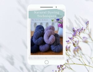 tablet with an ebook about natural dyeing techniques. in the background you can see a white surface and a purple statice flower.