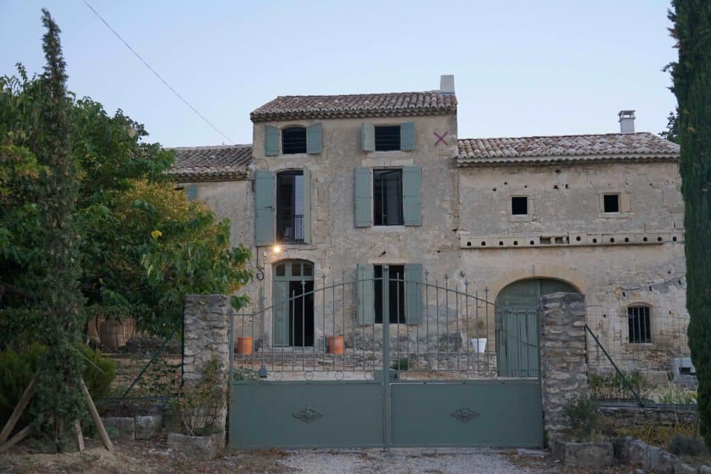 old house in the south of france with sage green shutters and gate